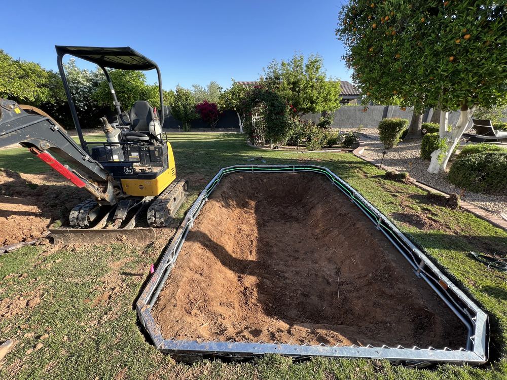 Mini excavator digging an in-ground trampoline hole